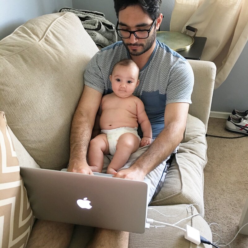 Doug working from home with his baby on his lap