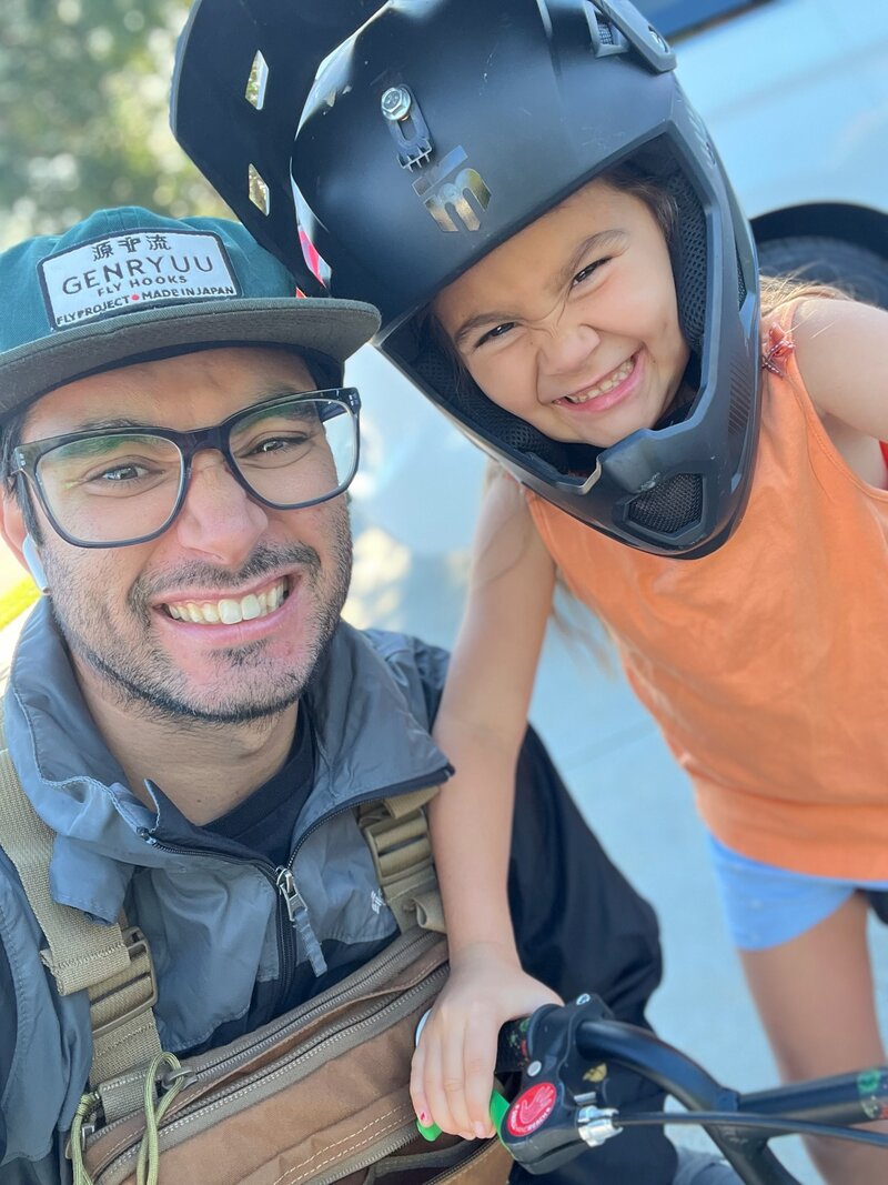 Doug outdoors with his daughter, wearing an everyday carry pack